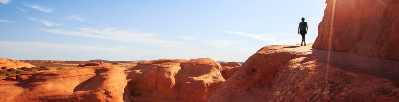 Distant view of a woman walking along a canyon